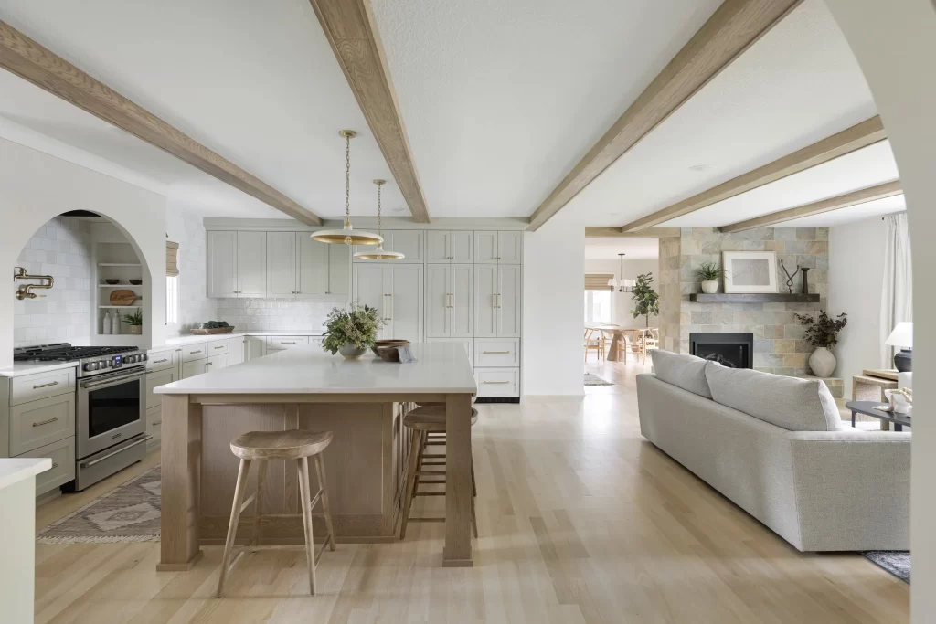 Kitchen and living room with natural wood floors and decorative natural wood ceiling beams