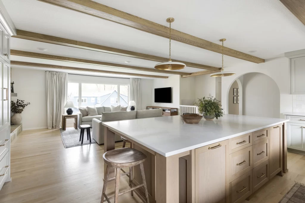 Kitchen and living room with large beams in ceiling and large center island