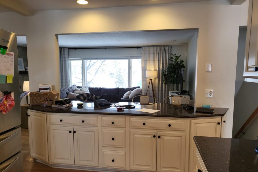 View to living room from kitchen with white cabinets